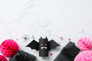 Black, paper bat with gifts for Halloween