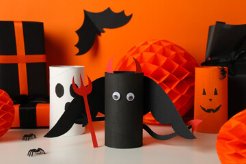 Gift boxes and paper halloween characters on orange background