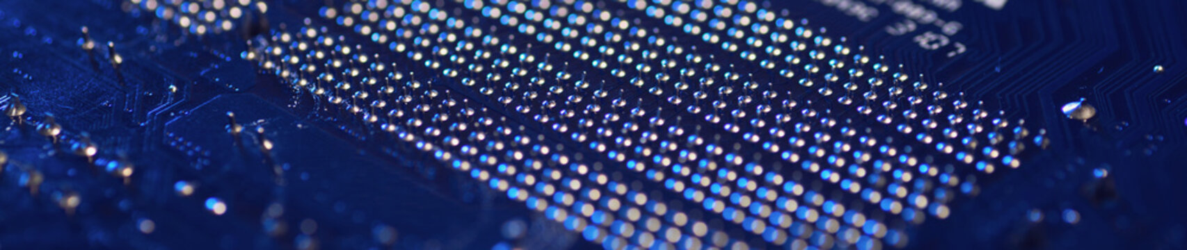 Motherboard close-up with contacts, desktop PC. Computer technology hardware components background