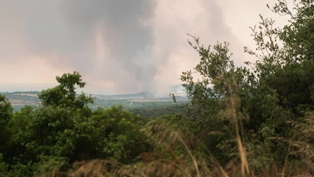 Wildfire Timelapse Smoke Large Brush Fire wide Shot pan left Greece Summer