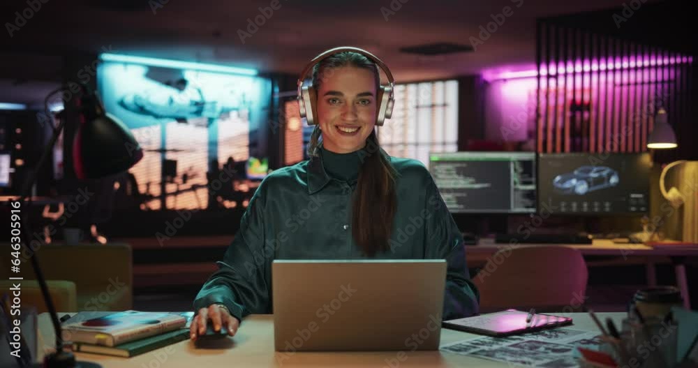 Poster zoom in portrait of a beautiful manager sitting at a desk in creative agency, using laptop computer.