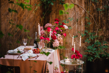 Table setting in restaurant. Location for surprise marriage proposal. Engagement. Decoration flowers, decor candles. Luxury romantic date. Candle light dinner setup table for couple on Valentines day.