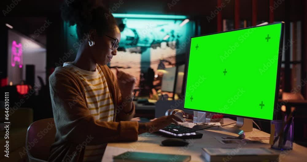 Poster Portrait of Black Female Working in Creative Agency, Implementing Modern Business Strategy for Clients. Successful Specialist Using Desktop Computer with Green Screen Mock Up Display