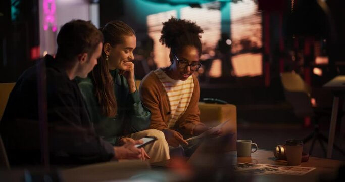 Slow Motion Portrait of Multiethnic Group of People Working on Developing Growth Ideas Based on Data. Energetic Teammates in a Creative Meeting Room in an Office Using Tablet and Laptop