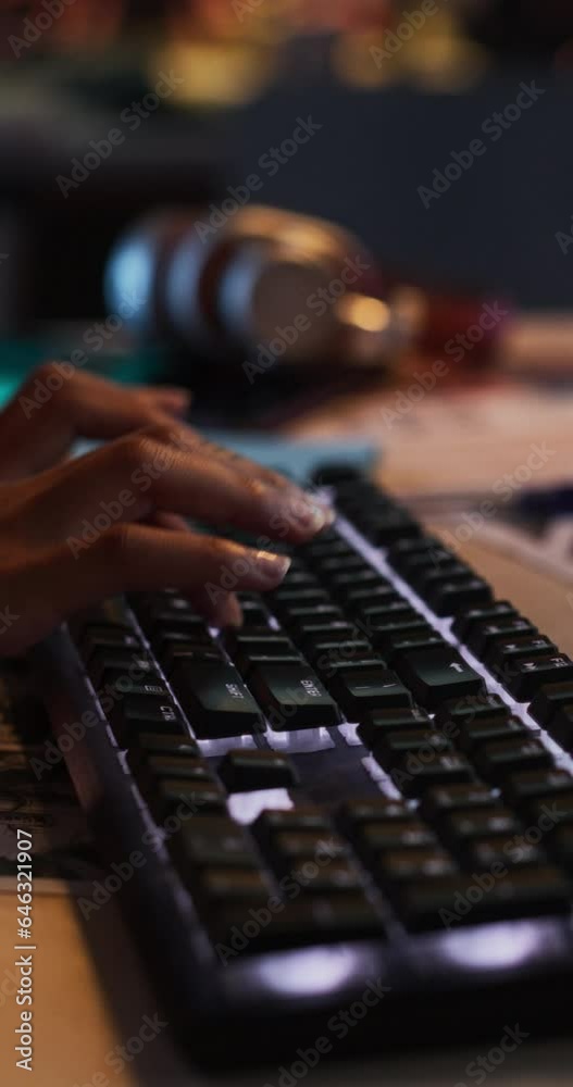 Poster vertical screen: close up footage of black woman's hands working on keyboard and monitor. female han