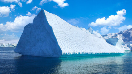 Boat excursion near icebergs of Kangia Fjord and Sermeq Kujalleq glacier in Ilulissat, Greenland. © eskystudio