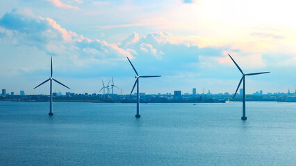 Renewable energy wind power plant and wind turbines along Denmark sea shoreline near Copenhagen.