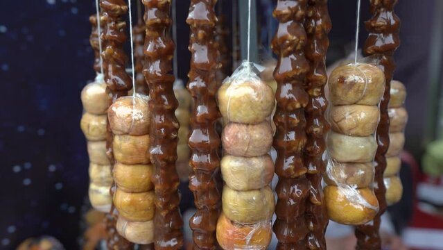 Street food market. Churchkhela.   Popular dessert cuisine of Caucasus.  Sugar and concentrated fresh grape juice. Sweet sujukh․