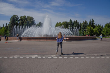 St. Petersburg, Russia - 27.08.2023, people walking in the park, rollerblading - Powered by Adobe
