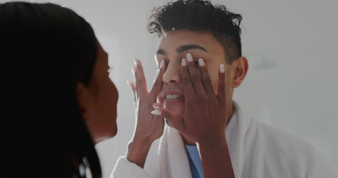 Beauty, love and woman doing skincare for boyfriend for health, wellness and self care routine. Happy, smile and female person rub lotion, spf or creme on man face for cosmetic dermatology treatment.