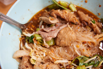 Rice stick noodles with braised beef and meatball in a bowl