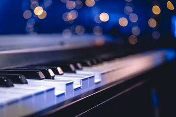 Piano keys close-up on a blurred background with bokeh.