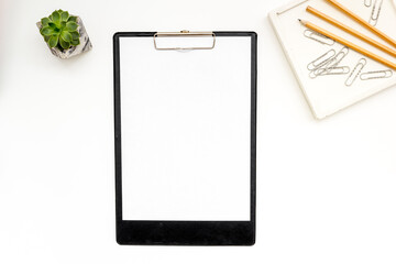 Empty blank clip board and office supplies, top view