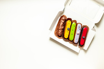 Set of eclairs cakes with different flavors. Sweet food background