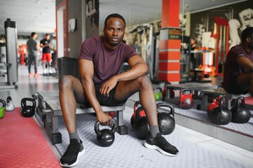 Fototapeta na wymiar African American young man doing workout at the gym