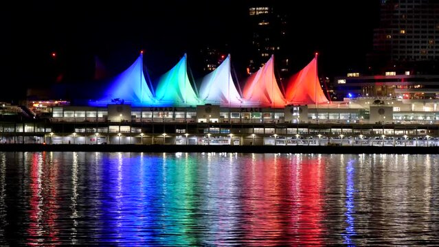 4k CANADA PLACE Sails of Light at Night Reflecting on water, Downtown Vancouver British Columbia, seen from Stanley Park sea wall. Home of the 2010 Olympic Games.