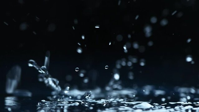 rain background. water droplets, splashes on a black background. slow motion