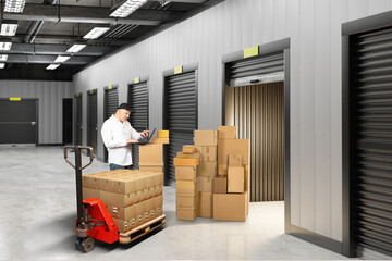 Storage auction. Man near warehouse unit. Boxes at entrance to storage container. Businessman...