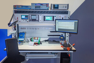 Industrial laboratory. Technologist desktop. Factory technician office. Engineer desk with monitors and electrical equipment. Place to test electronic devices. Equipment for industrial laboratory