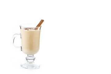 Homemade eggnog with cinnamon. Typical Christmas dessert isolated on white background. Copy space