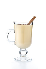 Homemade eggnog with cinnamon. Typical Christmas dessert isolated on white background