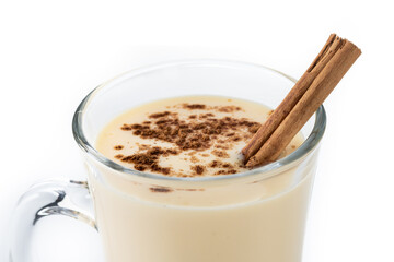 Homemade eggnog with cinnamon. Typical Christmas dessert isolated on white background. Close up