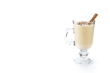 Homemade eggnog with cinnamon. Typical Christmas dessert isolated on white background. Copy space