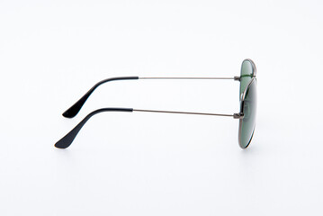 Fashion sunglasses black frames and green lens on white background.