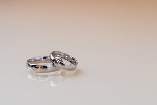 pair wedding rings a in ring on white background, top view flat lay