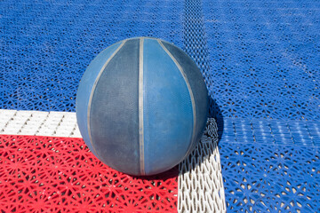 Basketball ball on a outdoor court.