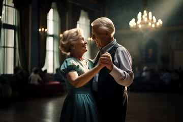 Fotobehang Elderly couple dancing a slow dance and enjoying each other at family reunion. Their children and grandchildren are in blurry background © Denniro