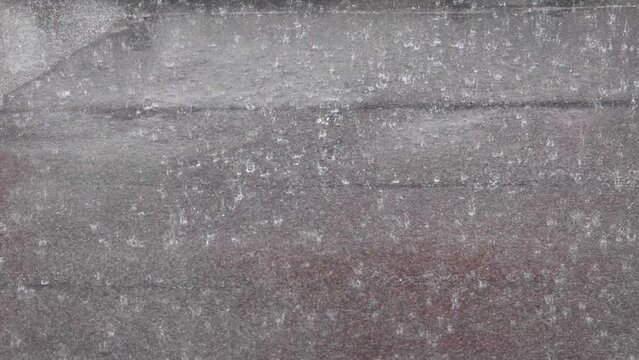 Heavy rain falling on a street during a thunderstorm