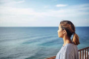 shot of a young woman looking at the sea while on vacation
