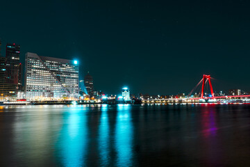 Immersed in the Timeless Beauty of Rotterdam's Nightfall, Where Skyscrapers Sparkle Amidst Reflections on the Water