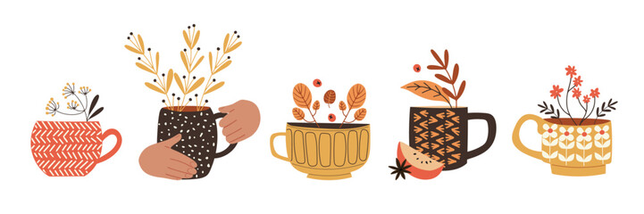 Cute set with cups and mugs, decorated with seasonal plants and branches. Herbal tea or mulled wine. Isolated vector illustration in flat design