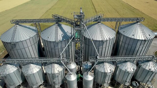 Modern industrial silo storage tanks for agriculture harvest crops, aerial shot
