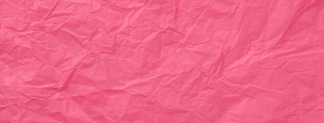 Texture of vintage crumpled red wrapping paper, closeup. Dark pink old background, macro.