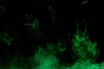 Green colorful dye on black background,Art abstract smoke texture,Colored liquid dye,Splash paint,Abstract color,Abstract Textures
