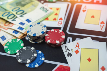Euro bills, poker play card and chips in a casino table. Casino Black Jack