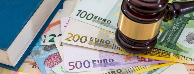 hammer gavel on euro banknotes on rusty table