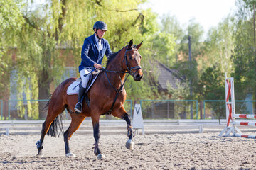 Young horseback sportsman on his course in showjumping competition