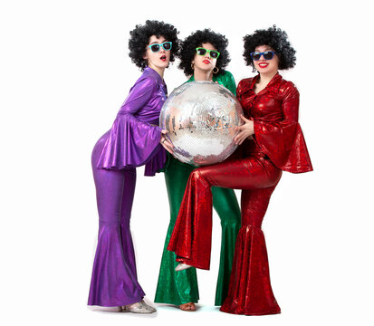A group of girls with a disco ball in colorful costumes in the fashion style of the seventies or eighties. Disco party on a white background.