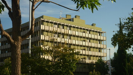 Modern building surrounded by wooded area at sunset in Barcelona
