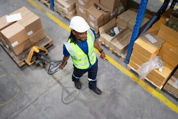 Multiracial warehouse worker pulling hand pallet truck loading cardboard package boxes stacking in storehouse. Foreman moving merchandise by hand lift pallet jack. Delivering goods, cargo transport.