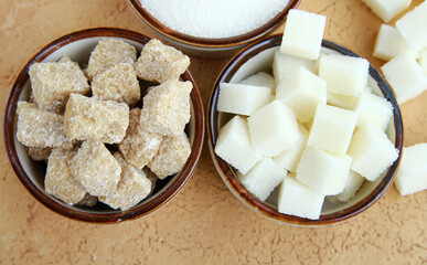 white and brown sugar in cups on the table