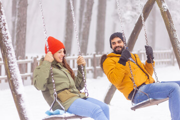 Couple swinging while on winter vacation