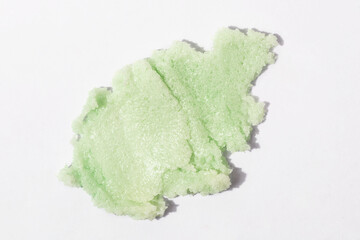 Matcha, green tea or seaweed scrub swatch on white background. Face, body or lip product.