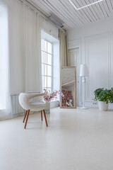 interior of a bright living room in a luxurious baroque style with white walls decorated with antique stucco