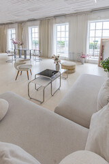 interior of a bright living room in a luxurious baroque style with white walls decorated with antique stucco