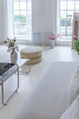 interior of a bright living room in a luxurious baroque style with white walls decorated with antique stucco